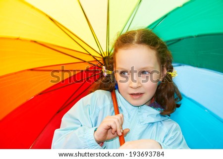 Little girl with a rainbow umbrella