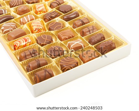Large box of sweet chokolate candies isolated on white.