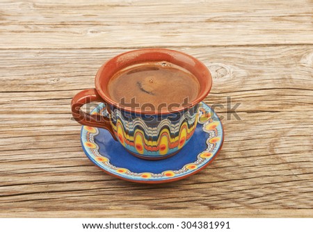 Ethnic cup of coffee on the beautiful old wooden background