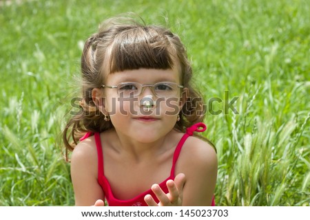beautiful girl with a flower on the nose,best focus on the lips and flower on the nose,background blurred