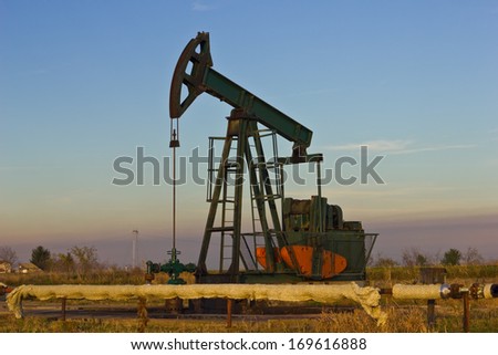 oil pump, best focus on pumps and pipes in front of the pump, the background soft focus
