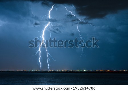 Strong electrical storm with a multitude of lightning strikes the ocean. 商業照片 © 