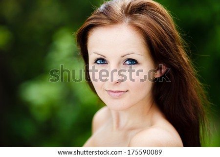 Beautiful Blue Eyed Woman smiling to a camera. Beauty Portrait. Green Background.