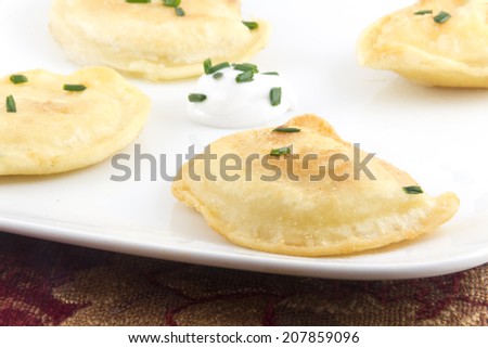 Delicious authentic Polish pierogies with chives and greek yogurt
