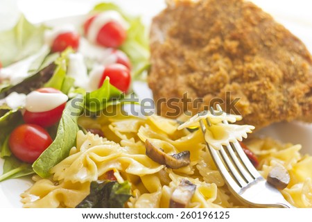 Blue cheese fried chicken with mushroom spinach and sundried tomato bowtie pasta and light salad