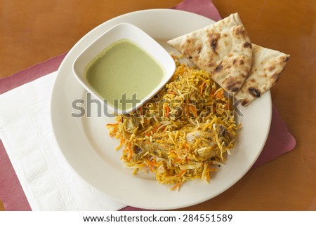 Indian biryani chicken with naan and mint coriander chutney sauce
