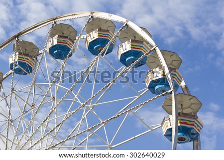 Close up summer carnival ferris wheel against blue sky