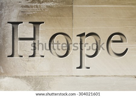 Engraving spelling the word Hope on textured old surface