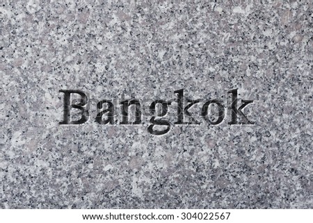 Engraving spelling the city Bangkok on textured old surface