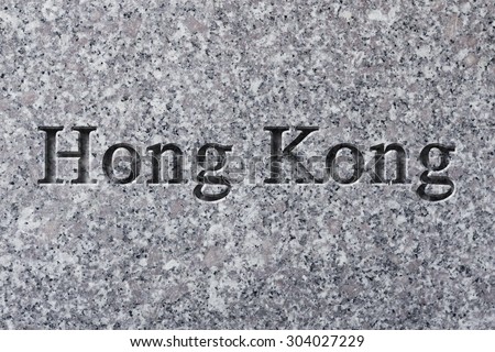 Engraving spelling the city Hong Kongon textured old surface