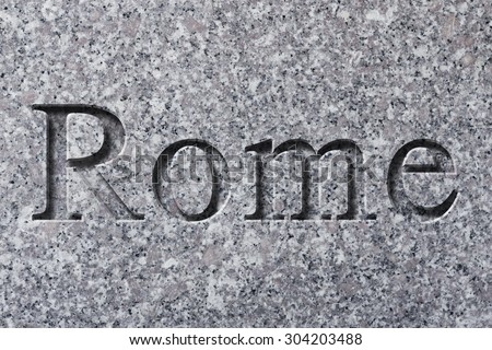 Engraving spelling the city Rome on textured old surface