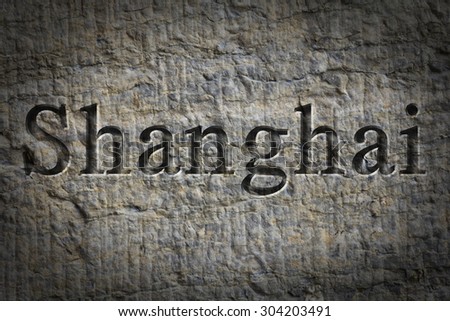 Engraving spelling the city Shanghai on textured old surface