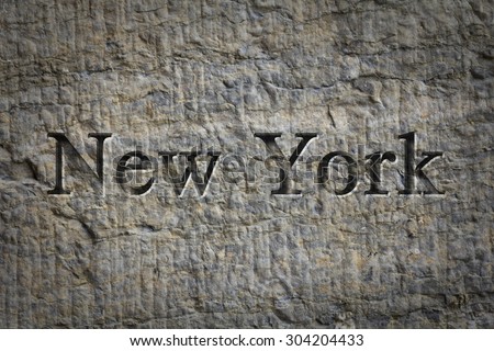 Engraving spelling the city New York on textured old surface