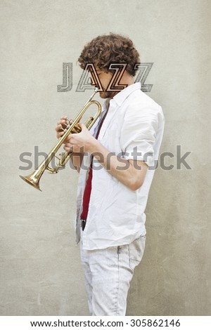 Curly haired man plays jazz trumpet outside
