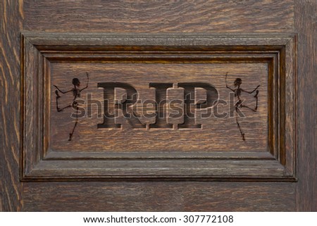 Engraved coffin spelling the letters RIP with Skeletons - rest in peace