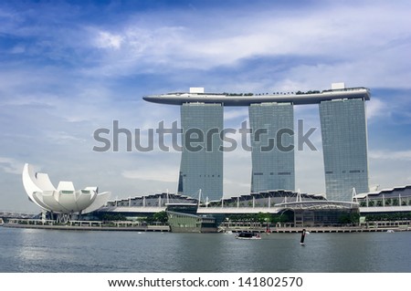 SINGAPORE - MAY 4: Marina Bay Sands and Science museum on May 4, 2013 in Singapore. Marina Bay Sands is billed as the world\'s most expensive standalone casino property at S$8 billion