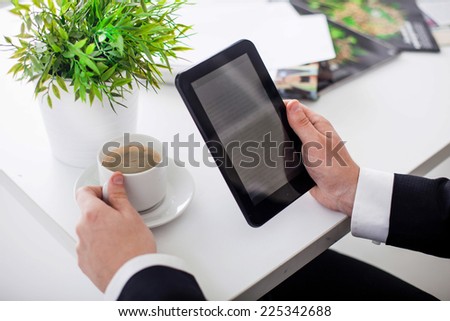business man in the office shows Tablet