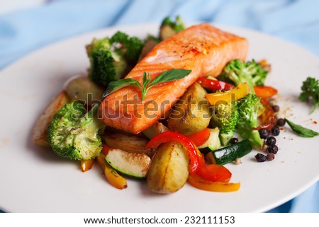 salmon fillet with vegetables and basil on a plate
