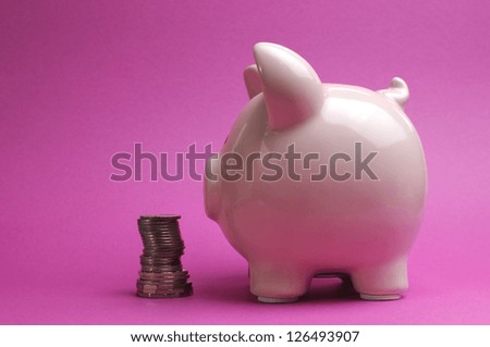 Pretty pink piggy bank with stack of coins for Savings and Shopping Sale concept.