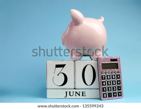 Calendar date for End of Financial Year, 30 June, for Australian tax year or retail stocktake sales, with piggy bank and pink calculator on sky blue background, with copy space.
