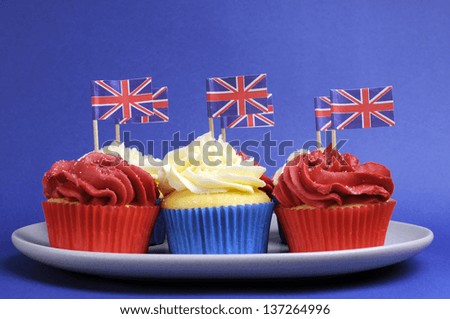 English theme red, white and blue cupcakes with Great Britain Union Jack flags for Queens Birthday weekend and national holiday party celebrations.