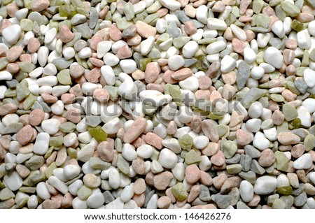 Pink, white and green pebbles gravel background abstract.