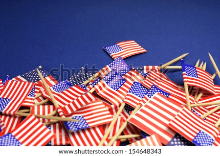 Abstract background of USA red, white and blue Stars and Stripes  toothpick flags for travel, national emblem, food background, or public holiday event, with copy space for your text here.