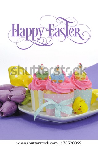 Happy Easter pink, yellow and blue cupcakes with cute chicken decorations and tulips on purple background for party or holiday treat, with beautiful sample text or copy space for your text here.