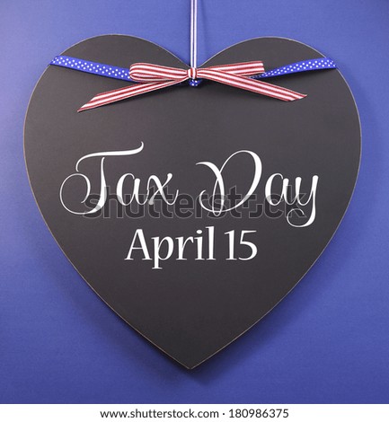 Tax Day, April 15, reminder greeting message with USA ribbon on a heart shaped blackboard against a blue background.