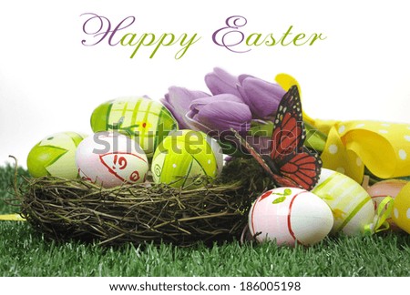 Happy Easter colorful pink and green Easter Eggs in nest with butterfly and yellow daffodils on green grass against white background with sample text or copy space.
