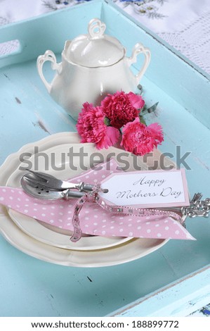 Happy Mothers Day aqua blue breakfast morning tea vintage retro shabby chic tray setting with antique fine china plates, pink carnations and sugar bowl.