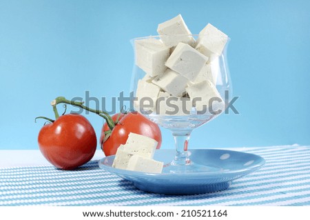 Health food healthy diet food group, dairy free products, with soy tofu in elegant glass bowl on blue background.