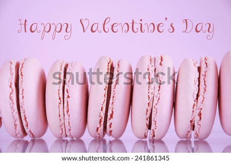 Happy Valentines Day pink macaroons on pink background with sample text greeting message.