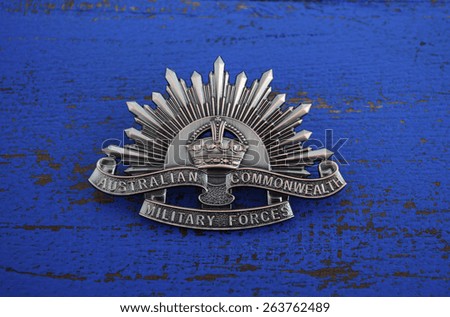 ADELAIDE, AUSTRALIA - MARCH 18, 2015: Australian Anzac WWI rising star hat badge on dark blue wood background.
