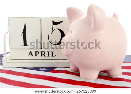 April 15 calendar for USA Tax Day with piggy bank on stars and stripes flag against a white background.