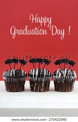 Happy Graduation Day party chocolate cupcakes with graduation cap hat topper decorations, in red and white party theme.