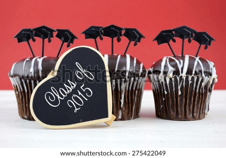 Happy Graduation Day party chocolate cupcakes with graduation cap hat topper decorations, in red and white party theme.