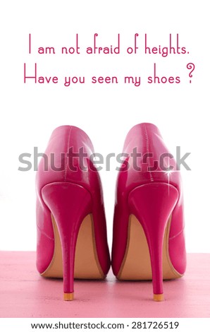 High Heel Shoe with funny Not Afraid of Heights quote on pink wood table.