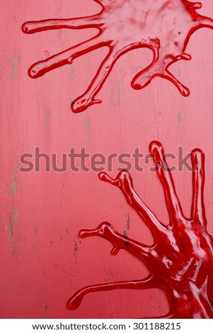 Halloween red wood background with bloody hand prints and copy space for your text here.