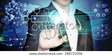 Virtual image of a Business man touching the process of triggering a software development process, which it connects the various systems globally through a single touch in a network and coding phase.
