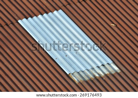 New silver corrugated iron between old. abstract lining background.