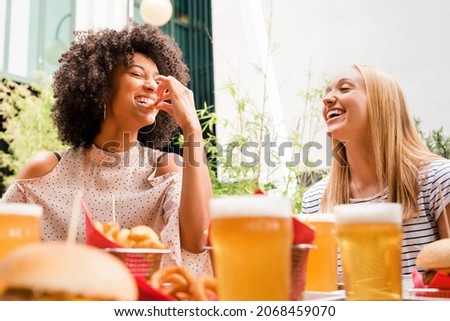 Similar – Image, Stock Photo Black woman enjoying fries and burger in restaurant