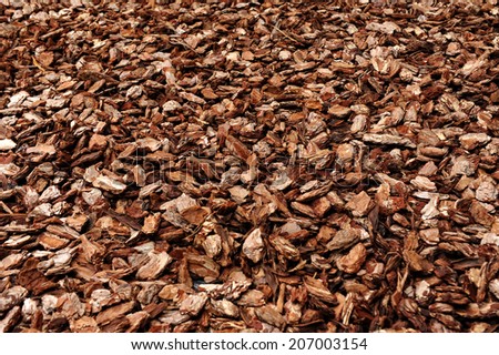 Cortex or wood chip background texture with small chips of natural wood to be used as a soil covering for mulch in the garden