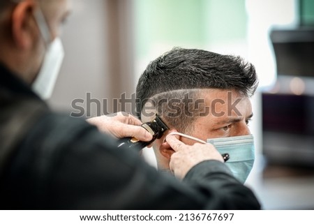 Similar – Image, Stock Photo Crop barber doing haircut for man