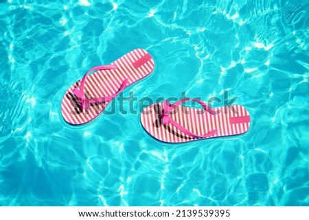 Similar – Image, Stock Photo rubber slippers float in clear water next to female legs