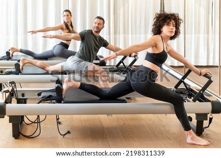 Similar – Image, Stock Photo Slender barefooted woman stretching body in bound angle pose in contemporary studio