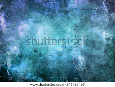 Abstract textured blue background in shades of blue blended in a grunge effect with central highlight for copy space