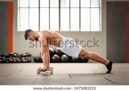 Similar – Image, Stock Photo Strong man performing handstand on sports ground