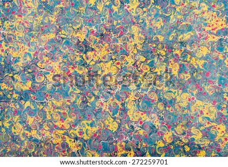 Pretty blue and yellow marble paper design in a full frame background pattern with blended swirls of color overlaid with a red stipple effect for vintage style books or documents