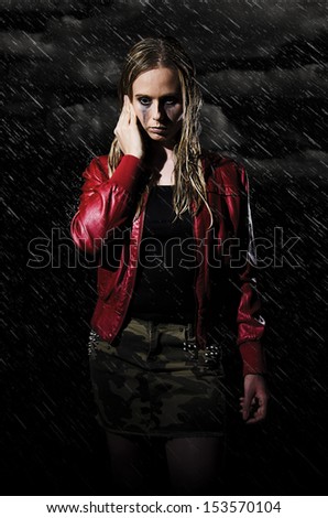 woman with wet hair and smudged makeup walking in the rain vertically cropped